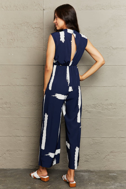 Printed Round Neck Cutout Jumpsuit with Pockets Sunset and Swim   