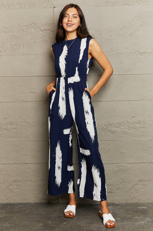 Printed Round Neck Cutout Jumpsuit with Pockets Sunset and Swim Navy S 